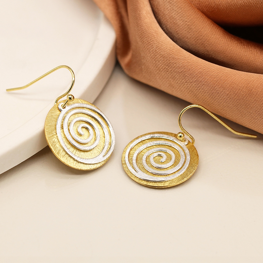 Faux gold-plated scratched disc earrings with a silver-plated spiral overlay, featuring a textured finish and mixed-metal design.