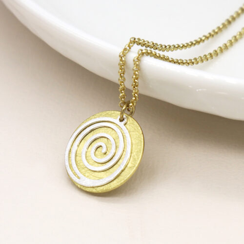 Faux gold-plated scratched disc necklace with a silver-plated spiral overlay, hanging from a delicate golden chain.